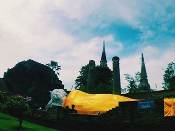 Yellow temple against buildings