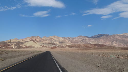 Road in desert against sky