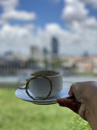 Person holding coffee cup