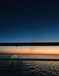 Scenic view of sea against clear sky during sunset