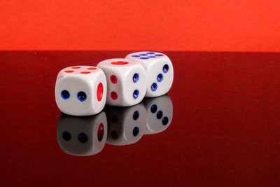 Close-up of dices on red background