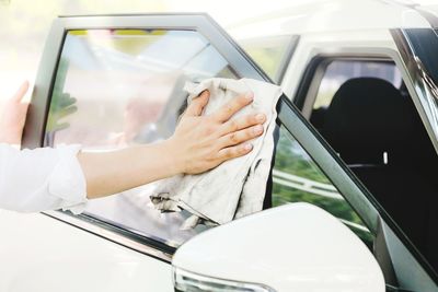 Close-up of hand cleaning car window