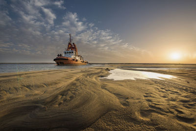 Scenic view of beach against sky during sunset