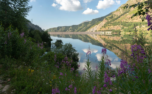 Scenic view of lake and mountains against sky