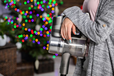 Midsection of woman holding equipment