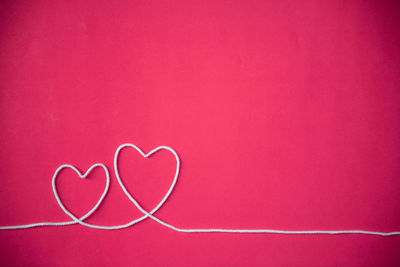 Close-up of heart shape on pink wall