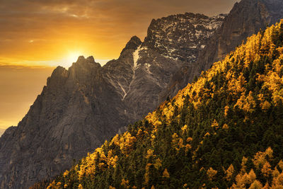 Scenic view of mountains against orange sky