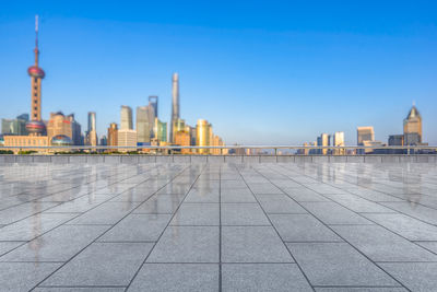 View of city buildings against clear sky