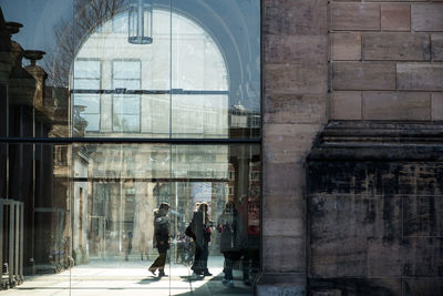 People walking in corridor of building