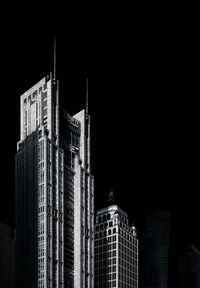 Low angle view of illuminated buildings against sky at night