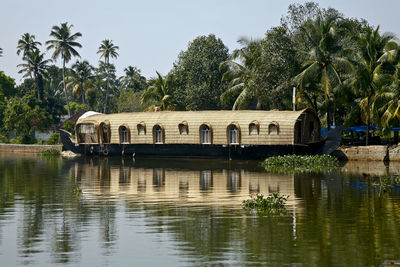 Palm trees by lake against sky