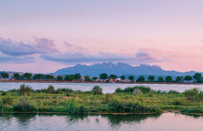 Scenic view of lake against sky during sunset