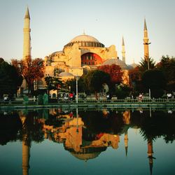 Reflection of hagia sophia on water against clear sky