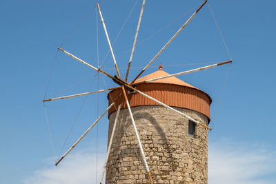 Old windmill at mandraki harbour in rhodes city on rhodes island, greece