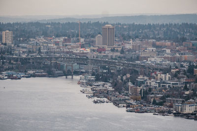 High angle view of buildings by sea against sky