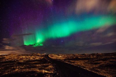 Geomagnetic storm over landscape at night