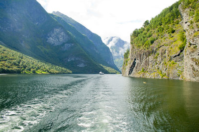 Scenic view of river amidst mountains against sky