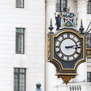 Close-up of clock against building