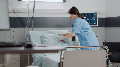 Side view of doctor examining patient in hospital