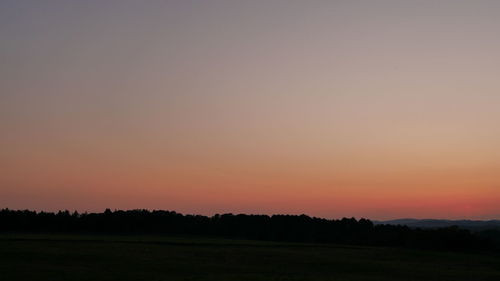 Scenic view of silhouette landscape against clear sky during sunset