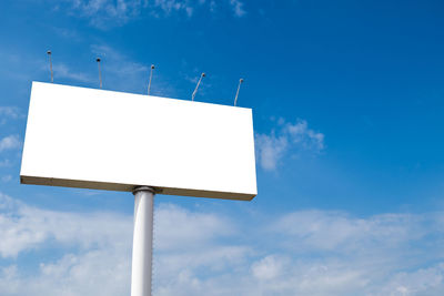 Large billboards with a cloudy sky background