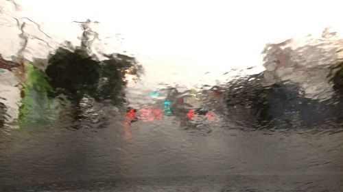 Close-up of wet road against sky