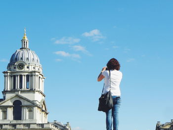 Rear view of woman photographing cathedral