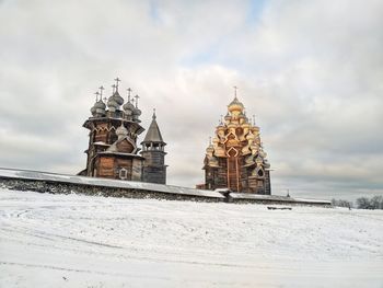 Traditional building against sky during winter