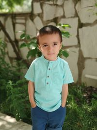 Cute boy looking away standing outdoors