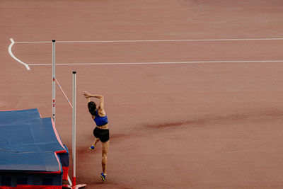 High jump girl athlete attempt at competition
