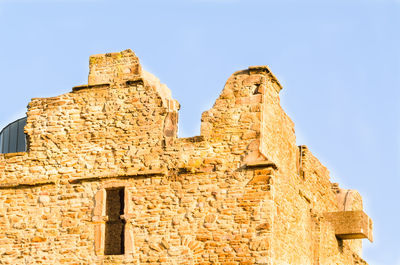 Low angle view of old building against clear sky