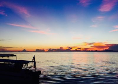Boat in sea at sunset