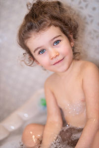 Portrait of cute baby girl in bathroom