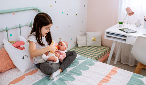 Mother and daughter on bed