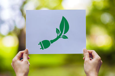 Midsection of person holding paper