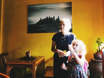 Women standing on table at home