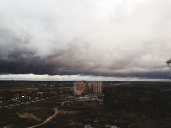 View of city buildings against storm clouds