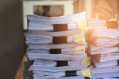 Close-up of documents stacked in office