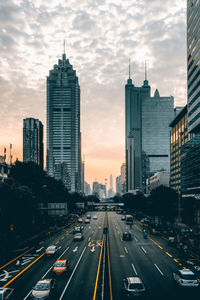 View of skyscrapers in city against cloudy sky