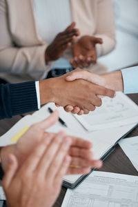 Midsection of business people working on table