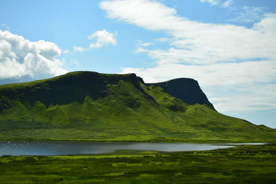 Scenic view of green landscape against sky