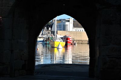 Reflection of people on boat sailing in sea