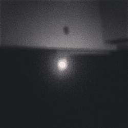 Low angle view of illuminated moon against sky at night