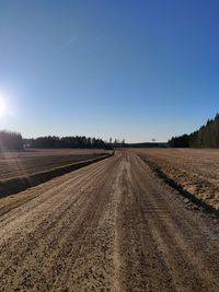 Scenic view of agricultural field against clear blue sky