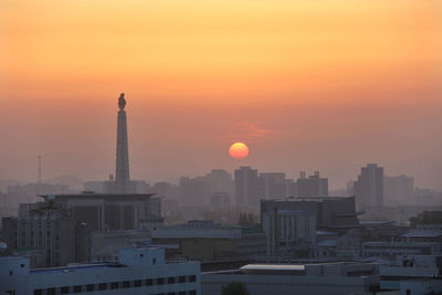 Cityscape against sky during sunset