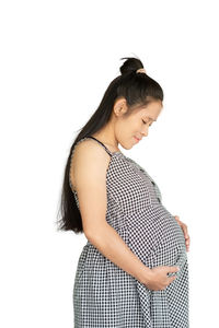 Young woman standing against white background