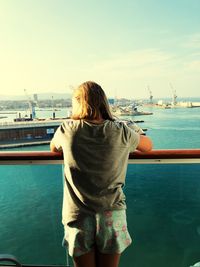 Rear view of woman looking at sea against sky