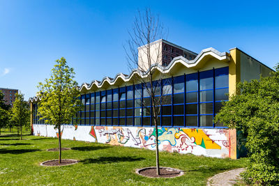 Graffiti on building against clear blue sky