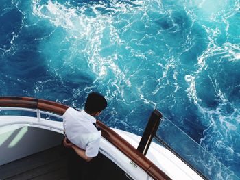 High angle view of boat captain looking at waves