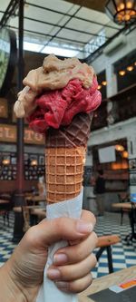 Hand holding ice cream cone